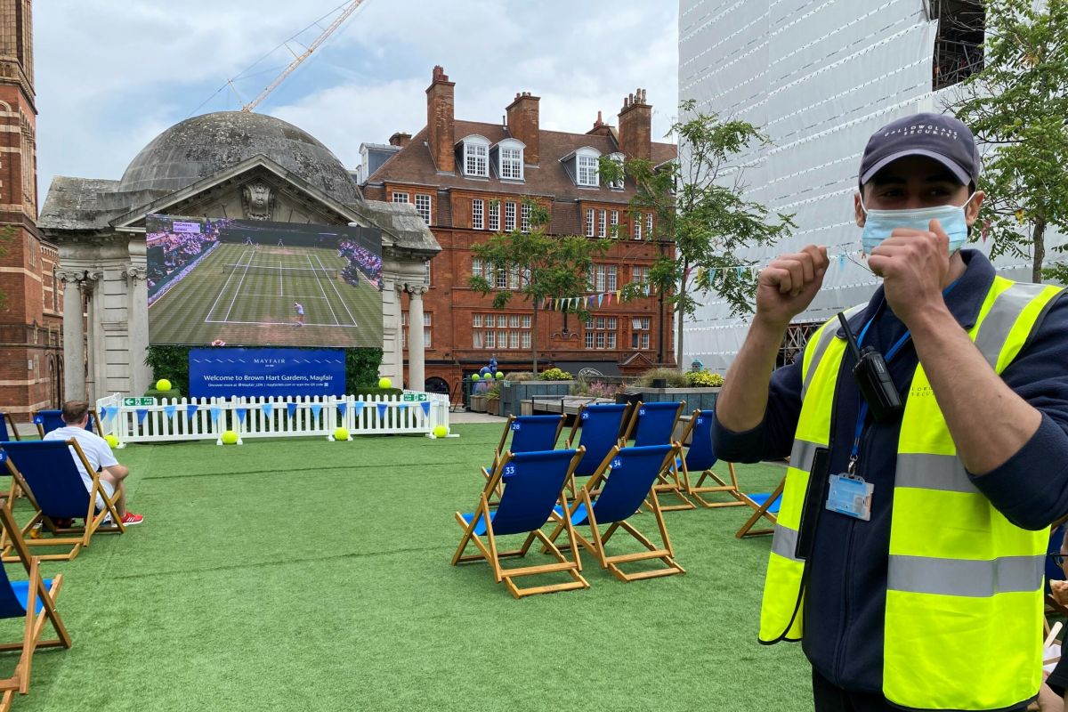 A Gallowglass Security officer on duty at the Wimbledon screening in Brown Hart Gardens in Mayfair.